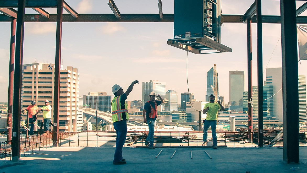 Three people at work on a construction site